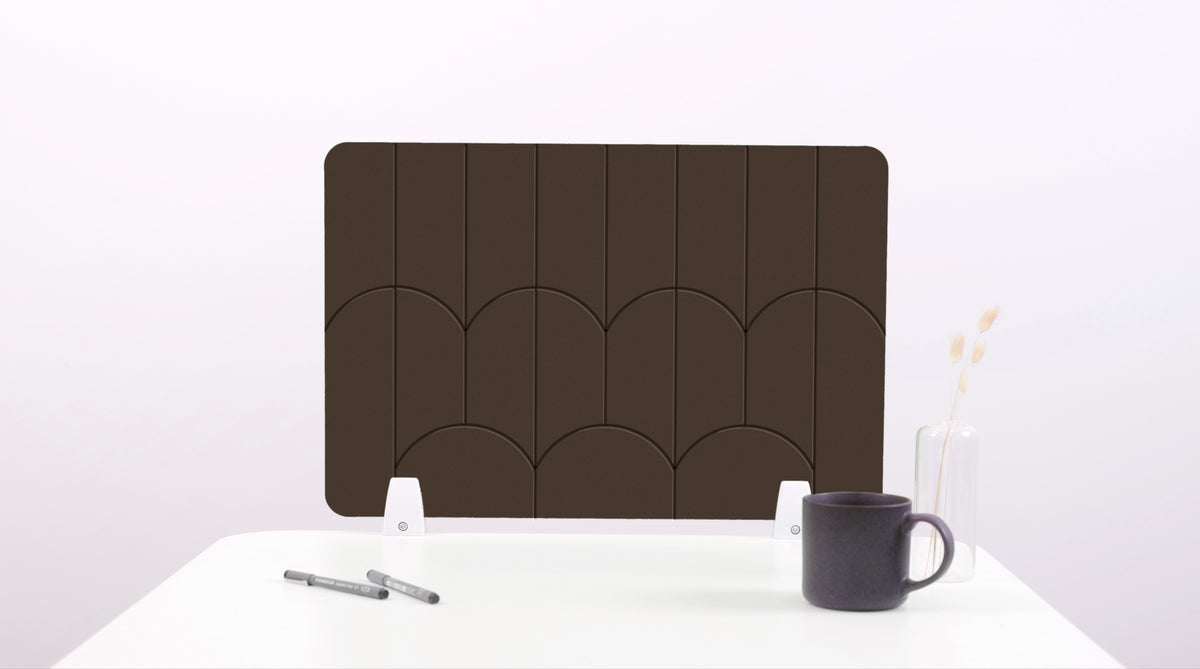 A dark brown colored felt desk divider with a scalloped design of lines and arches.