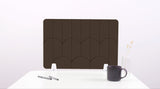 A dark brown colored felt desk divider with a scalloped design of lines and arches.