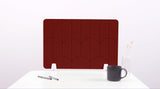 A red colored felt desk divider with a scalloped design of lines and arches. 