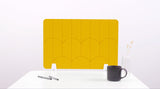 A yellow colored felt desk divider with a scalloped design of lines and arches. 