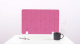 A pink felt desk divider with a scalloped design of lines and arches. 