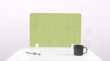 A light green colored felt desk divider with a scalloped design of lines and arches. 