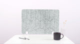 A nickel colored felt desk divider with a scalloped design of lines and arches. 
