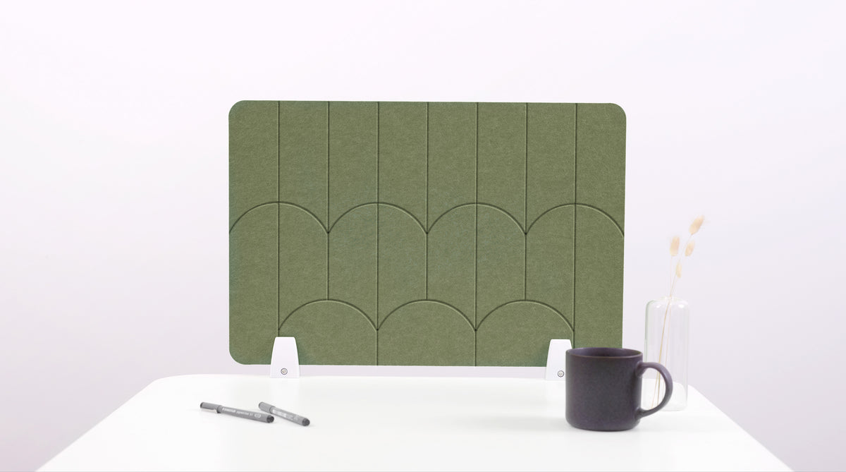 An olive green colored felt desk divider with a scalloped design of lines and arches. 
