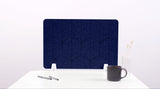 A navy blue colored felt desk divider with a scalloped design of lines and arches. 