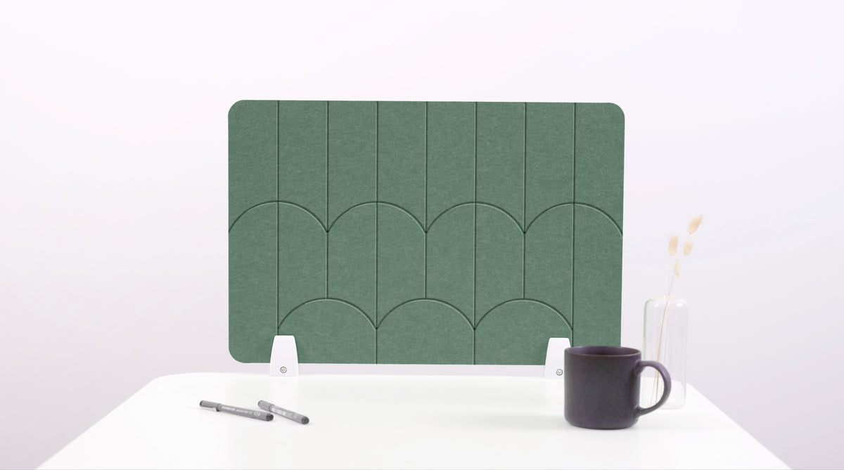 A green colored felt desk divider with a scalloped design of lines and arches. 