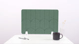 A green colored felt desk divider with a scalloped design of lines and arches. 