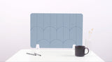 A powder blue colored felt desk divider with a scalloped design of lines and arches. 