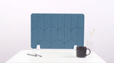 A slate blue colored felt desk divider with a scalloped design of lines and arches. 