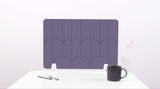 A purple colored felt desk divider with a scalloped design of lines and arches. 