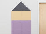 House-shaped pinboard with gray triangular roof, cream middle section, and purple bottom sections divided into grid squares.