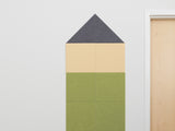 House-shaped pinboard with gray triangular roof, cream middle section, and green base panels divided by grid lines.