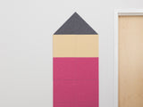 Cork pinboard in pencil shape with dark gray tip, cream middle section, and pink lower sections.