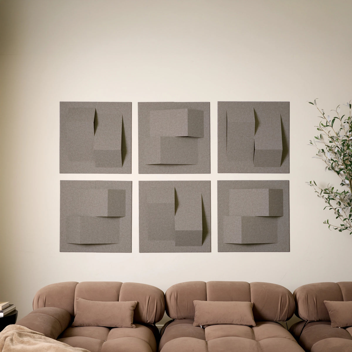 Grayish brown felt acoustic tiles above  brown couch