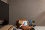 Brown acoustic wall panels on wall behind chair and tv