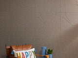 Brownish grey Felt Right tiles on wall behind chair