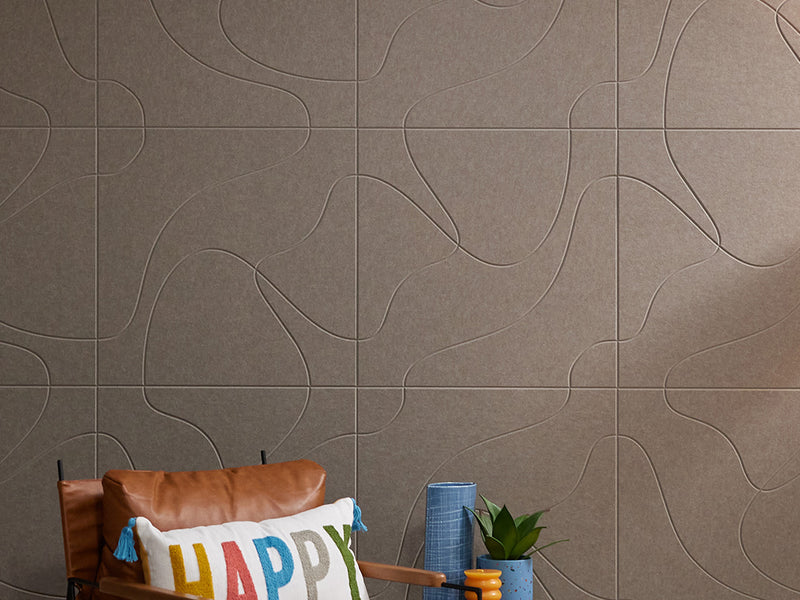 Brownish grey Felt Right tiles on wall behind chair