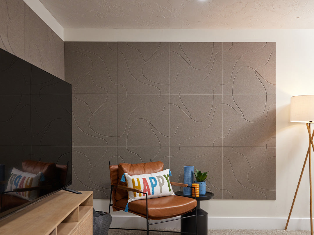 Brownish grey Felt Right tiles on wall behind tv and chair