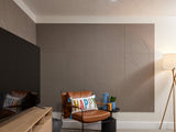 Brownish grey Felt Right tiles on wall behind tv and chair