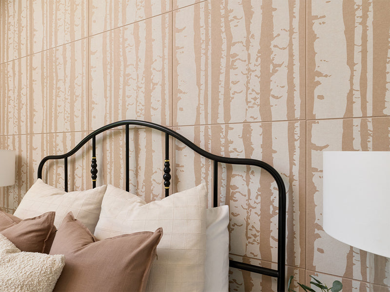 An angled, up close shot of the Felt Right printed aspen tiles with a bed and lamp in the foreground.