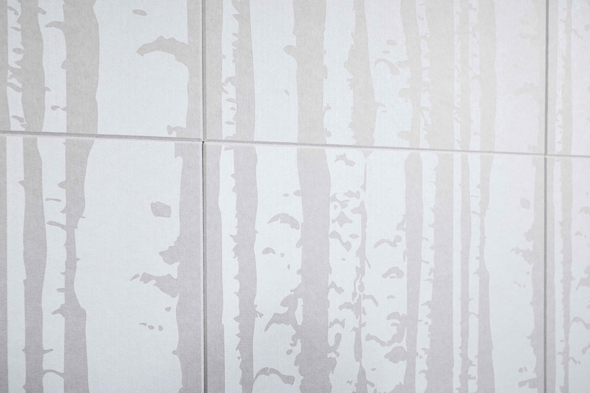 White tiles with a subtle tree pattern on a white background