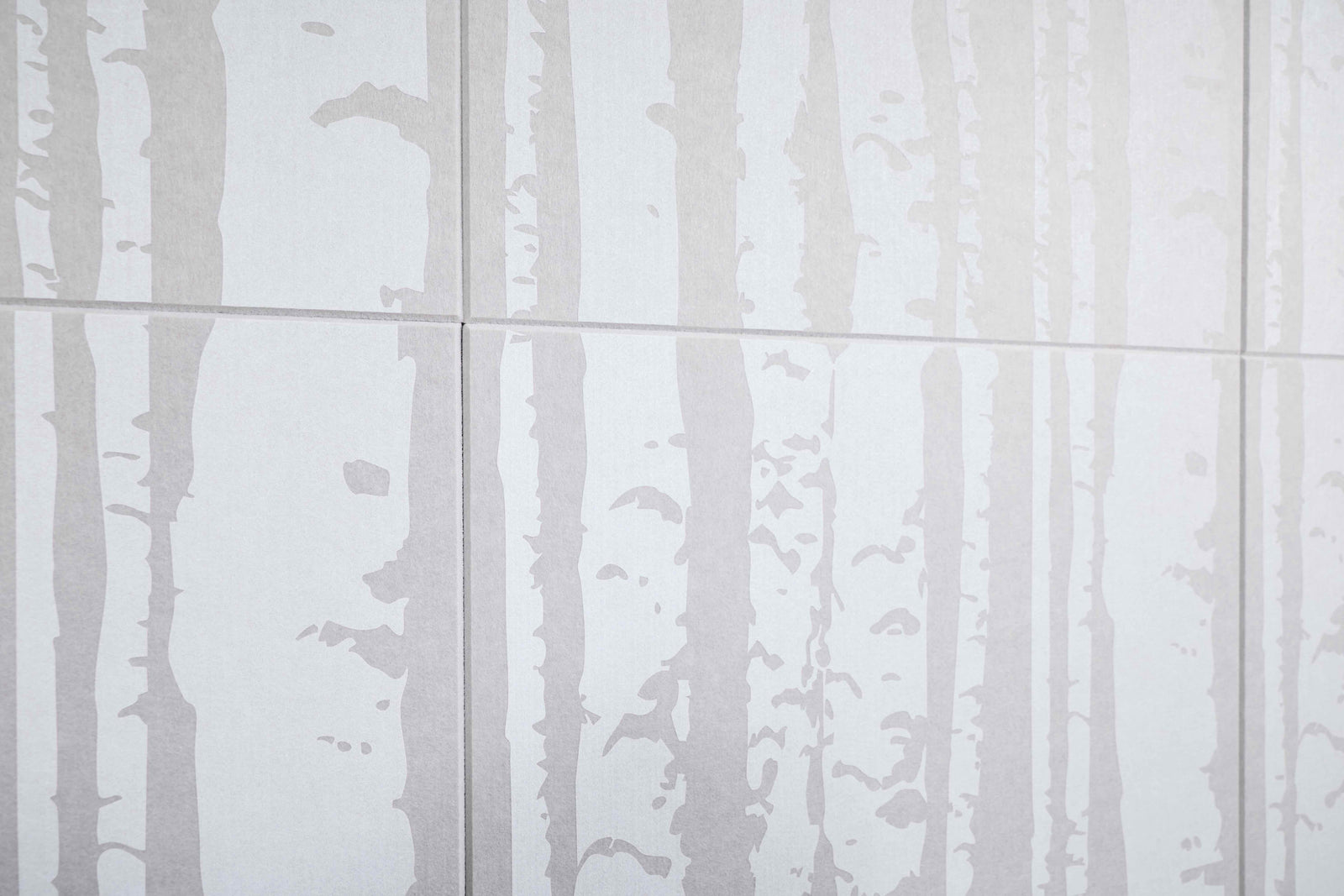 White tiles with a subtle tree pattern on a white background