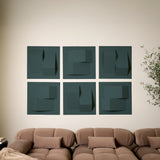 Blue-green acoustic felt tiles with peak dimensions on a wall above a couch