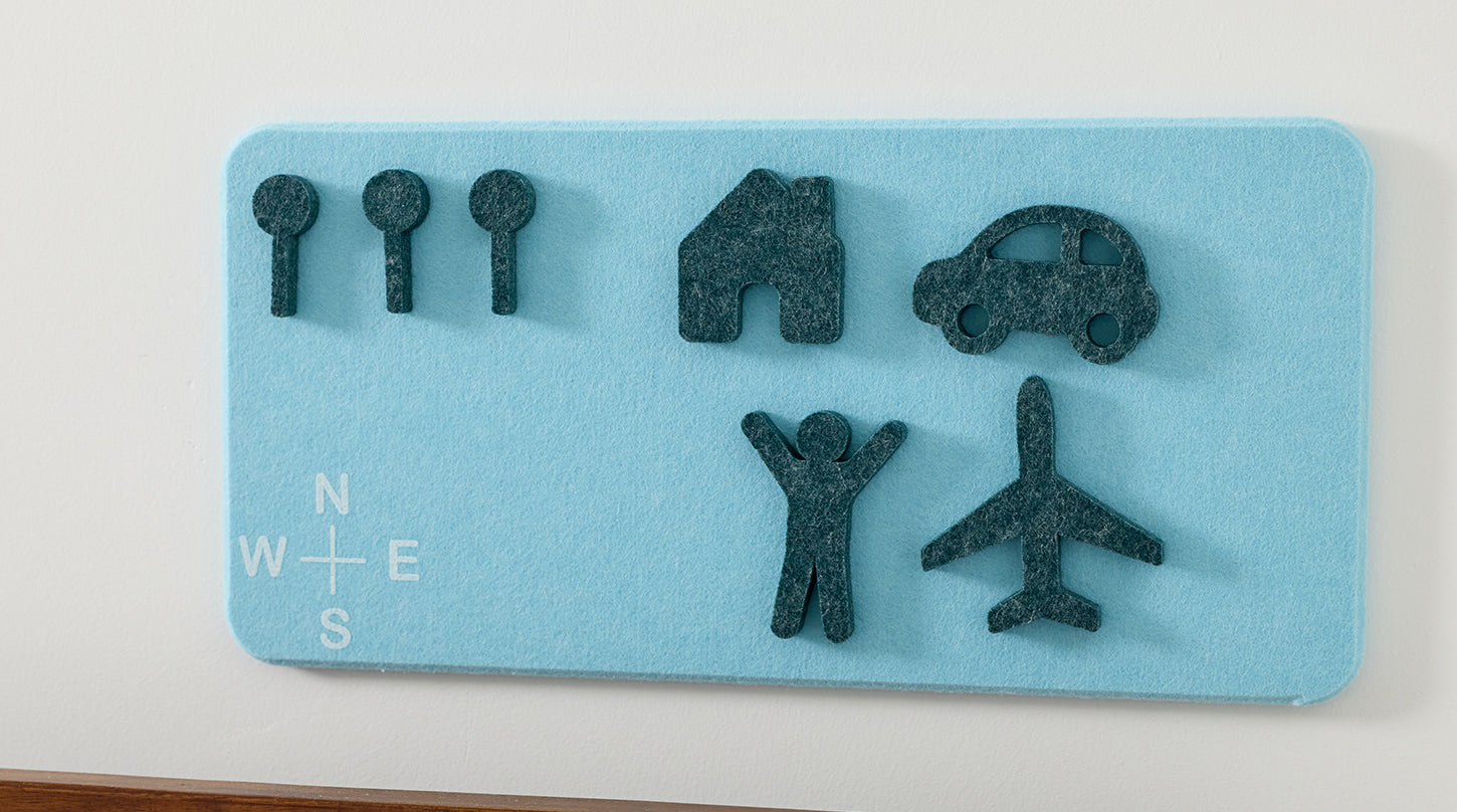 Set of dark felt shapes on a blue felt board with white text