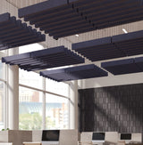 Dark navy acoustic ceiling panels suspended in a modern office interior with large windows and a textured dark accent wall.