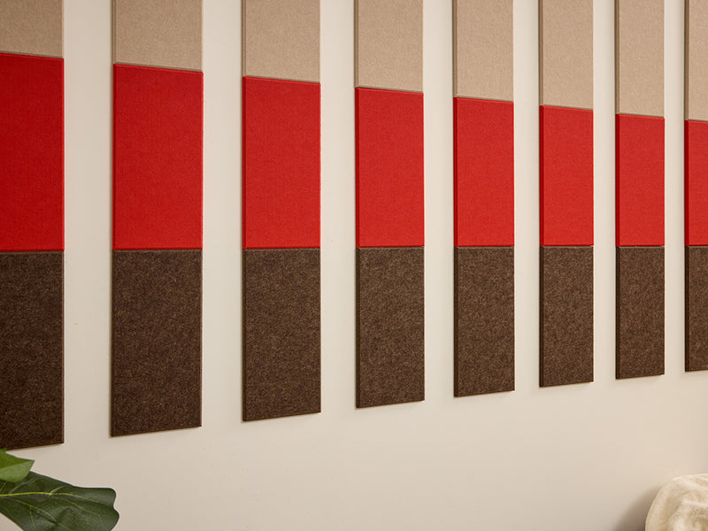 Acoustic panels with red and brown sections on a wall