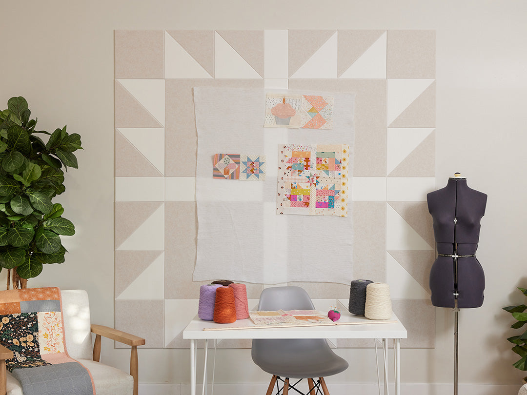 Quilted wall hanging with geometric pattern in a home setting