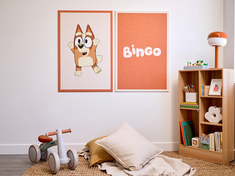 Children's room with a cartoon dog illustration and 'Bingo' text on the wall, a wooden bookshelf, and toys.
