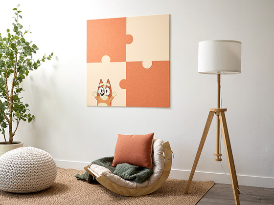 Room interior with Bluey wall art that looks like a puzzle piece.