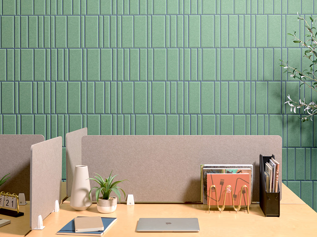 Modern office desk with green acoustic accent wall