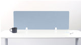 Blue desk divider panel with white mounting brackets on white desk surface.