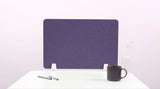 Purple desk divider with white base clips positioned on white desk surface.