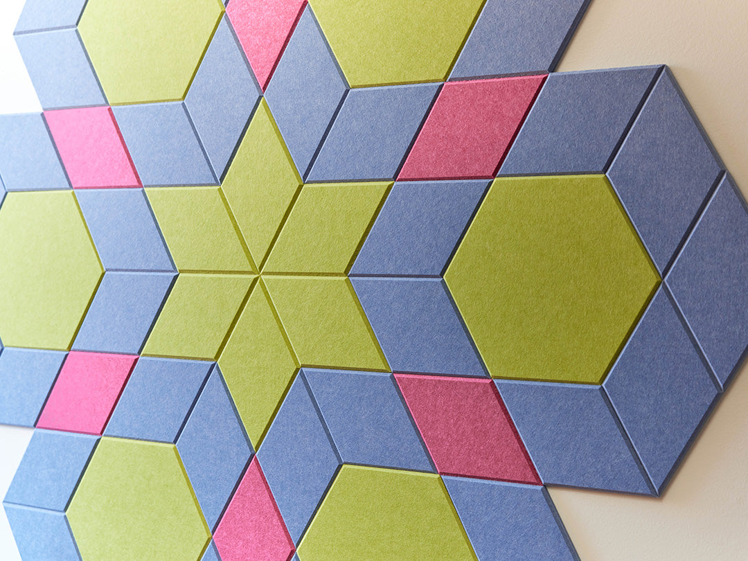 Hexagonal foam tiles in blue, green, and pink arranged in a geometric pattern.