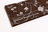 Close up of a brown felt sample for wall panels with printed flowers