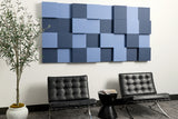 Blue acoustic 3d boxes on wall above chairs