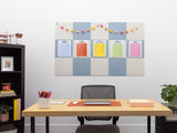 Office setup with a desk, chair, and colorful bulletin board on a white wall.