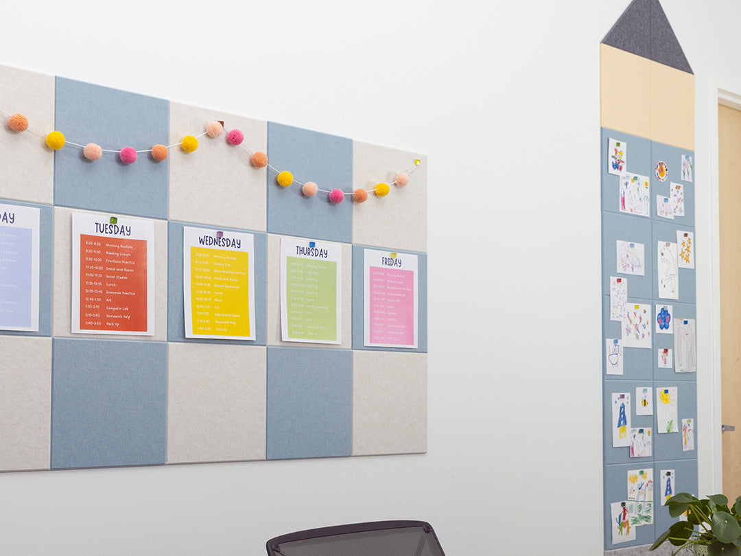 Felt board with colorful magnetic markers and a wall with pinned papers in an office setting.