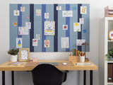 Blue pinstripe bulletin board with vertical navy and gray stripes, displaying various child's drawings and artwork cards.