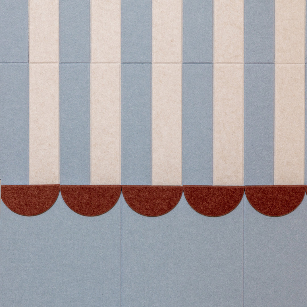 Textile pattern with vertical stripes and a scalloped edge on a blue background