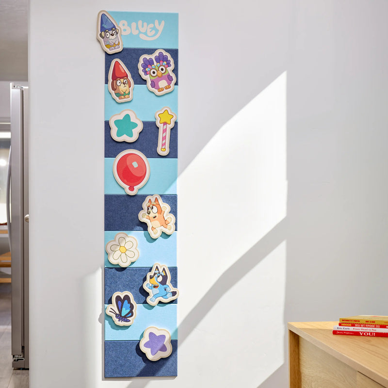 Bluey and Friends felt growth chart mounted on a wall