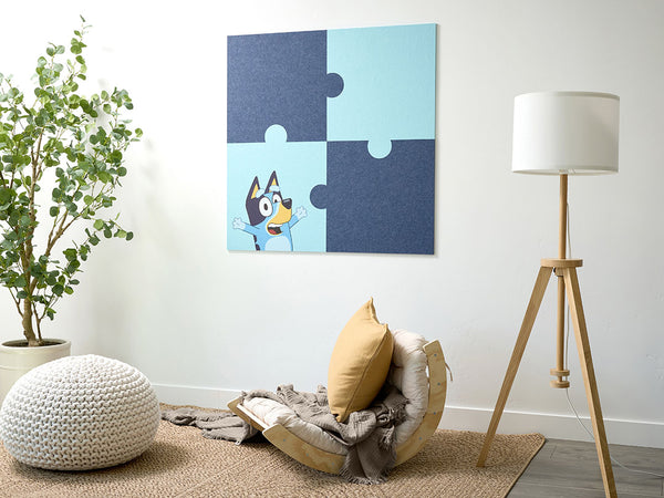 Jigsaw puzzle wall art with a Bluey the dog in a living room setting, light blue, dark blue design. DIY, easy, sticks to wall.