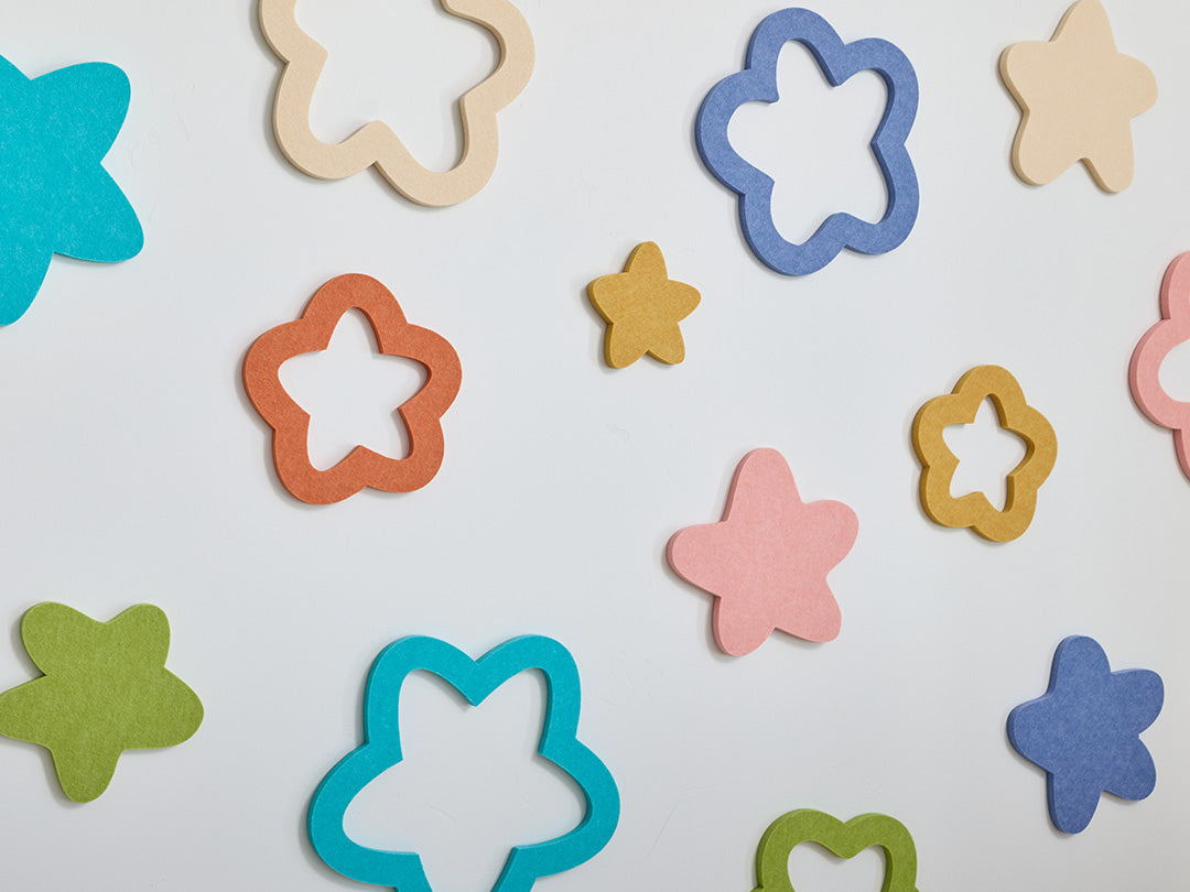 Colorful star-shaped cutouts on a light gray background