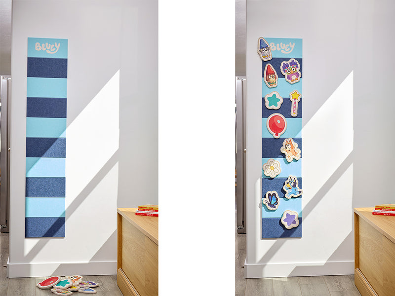 Children's felt  growth chart with cartoon Bluey characters on a white wall