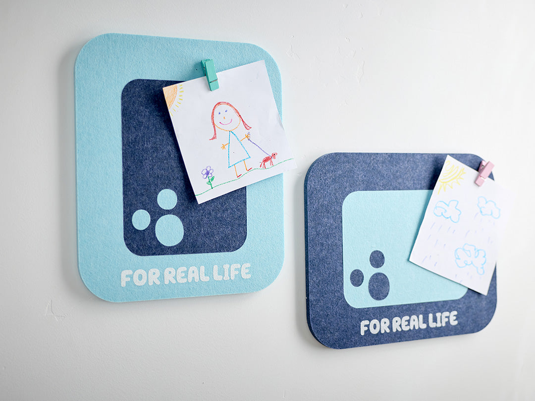 Two bluey themed felt tiles with kid's art pinned to it.