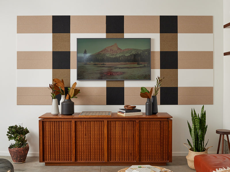 Felt Right wall art design in shades of brown, cream, and black on a wall with art mounted on it in a living room 