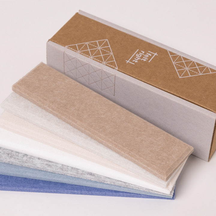 Warm neutral and blue felt samples by cardboard box